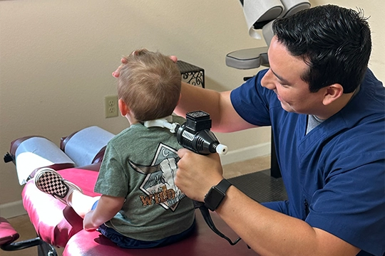 Chiropractor Boerne TX Sid Moreno With Pediatric Patients Neck